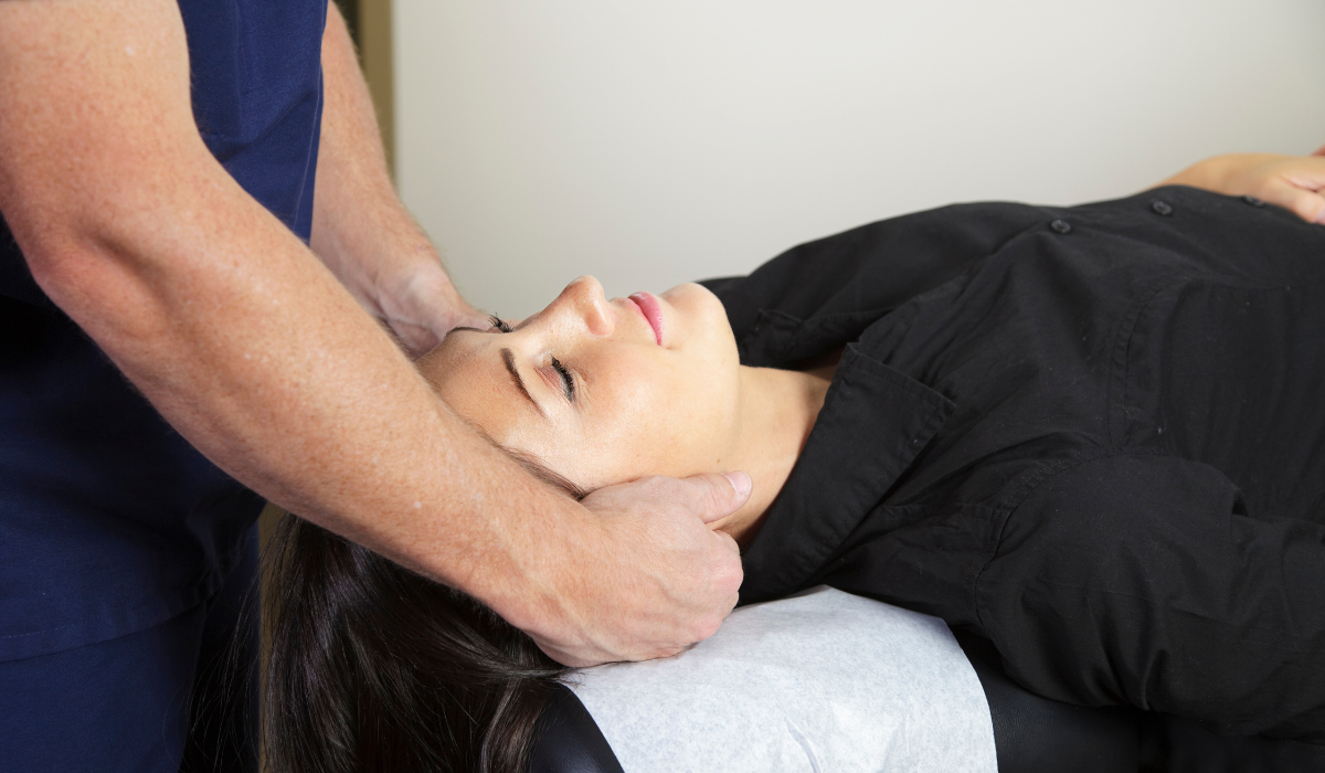 Licensed massage therapist performing targeted neck and upper shoulder therapy in a clinical Pottsville, PA setting