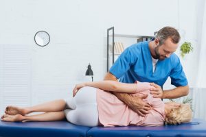 chiropractor massaging back of patient